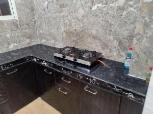 a stove sitting on top of a counter in a kitchen at Mig's Suite in Darjeeling