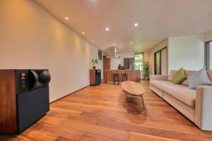 a living room with a couch and a table at Altitude -アルティチュード-939 富士山の麓グランピング in Fujiyoshida