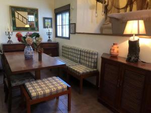 a living room with a table and chairs and a lamp at Charming Villa in Punta Umbría with Private Pool in Punta Umbría