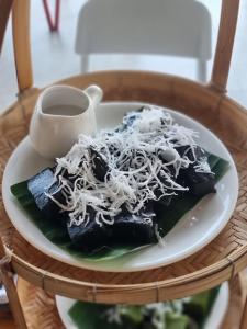 a plate of food with noodles on a table at Destino Hotel Surin in Ban Khok Kachai