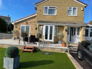 a house with a lawn in front of it at Mountain View in Kenfig Hill
