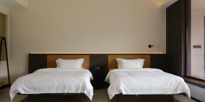 Letto o letti in una camera di Huangshan Yixian Pumanmanju Hotel