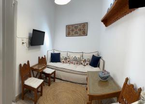 a living room with a couch and a table and chairs at Calliope's house in Skiros