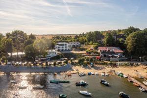 an aerial view of a beach with boats in the water at Domek Letniskowy 4E nad jeziorem nyskim in Skorochow
