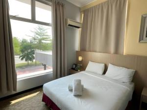 Postel nebo postele na pokoji v ubytování Seeds Hotel Kuala Selangor