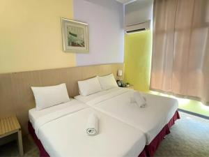 Postel nebo postele na pokoji v ubytování Seeds Hotel Kuala Selangor