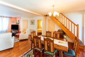 a dining room and living room with a staircase at Maison de ville in Saint-Jean-de-Luz