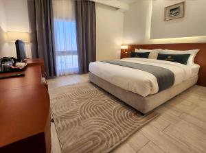 Postel nebo postele na pokoji v ubytování AMR ACACIA Hotel