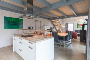a kitchen and dining room with a table and chairs at Schwan 291 in Mirow