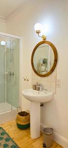 a bathroom with a sink and a mirror at Chez Flader - Le Verveine - Neuf & Moderne Centre De Langeac in Langeac +11 photos