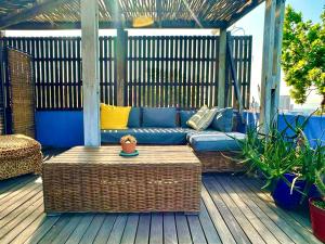 a blue couch sitting on a wooden deck at Casa Finchette rooftop apartment with panoramic views of Table Mountain in Cape Town