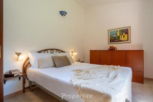Giường trong phòng chung tại Villetta de Pedra by Propertize - Palm Village