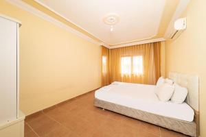Postel nebo postele na pokoji v ubytování Sevgi Tatil Sitesi