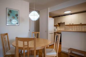 a kitchen and dining room with a table and chairs at AT139 Els Pins, 1ra línea de la playa, piscina, airco, in Torredembarra +23 photos