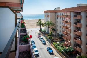 a view from the balcony of a building with a beach at AT139 Els Pins, 1ra línea de la playa, piscina, airco, in Torredembarra