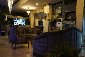 a living room with a couch and a tv at Safir Hotels Silivri in Silivri