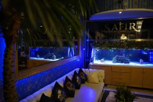 a room with a couch and a fish tank at Safir Hotels Silivri in Silivri
