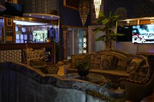 a living room with couches and a table and a tv at Safir Hotels Silivri in Silivri