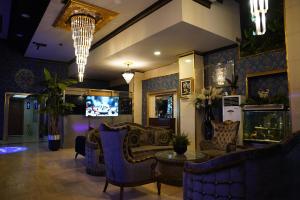 a lobby with couches and chairs and a television at Safir Hotels Silivri in Silivri
