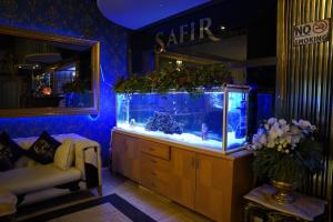 a room with a large fish tank on a dresser at Safir Hotels Silivri in Silivri