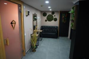 a waiting room with a black leather chair and a door at Safir Hotels Silivri in Silivri