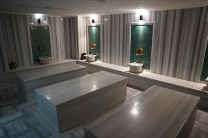 a row of benches in a room with windows at Safir Hotels Silivri in Silivri