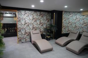 a waiting room with three chairs and a wall at Safir Hotels Silivri in Silivri