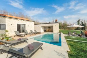 a backyard with a swimming pool and patio furniture at Villa Harmony for 8 people in Central Istria with 50 m2 private pool and sea view in Pinezići