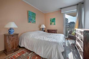 a bedroom with a white bed and a window at Appartement pour 4 au Pouliguen, avec terrasse in Le Pouliguen