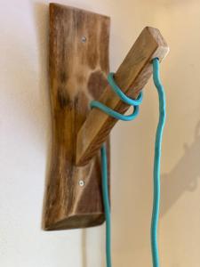 a wooden hook with a rope hanging on a wall at PaChaSi Samui Bungalows in Ban Bang Po