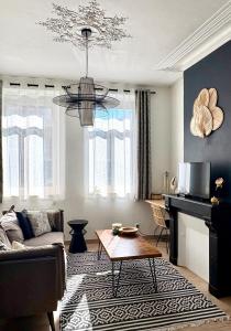 un salon avec un canapé et une table dans l'établissement L'Art appart' - T2 - Lit King Size - Proche centre, à Amiens