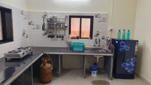 a kitchen with a counter top and a refrigerator at Rukhmini Niwas in Pural
