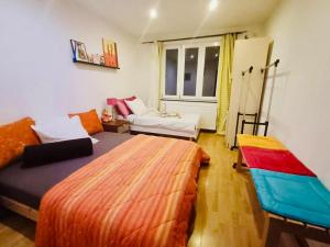 a bedroom with two beds and a couch at Plein centre de Visé in Visé