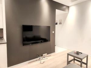 Una sala de estar con un televisor de pantalla plana en una pared. en P1-Central-Cosy flat Suit All Globetrotters-2rooms, en Oslo 3 fotos más