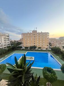 a large blue swimming pool in front of a building at SeaViev Torrevieja in Torrevieja
