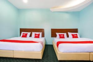 Postel nebo postele na pokoji v ubytování OYO 44094 Bangi Lanai Hotel