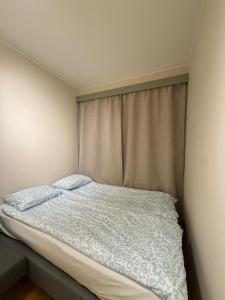 a bed with two pillows in a bedroom at PP1b-Central-Cosy studio flat Suits globetrotters in Oslo