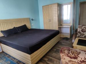 Postel nebo postele na pokoji v ubytování Rajgundha