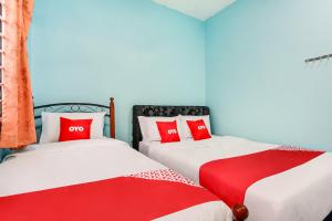 Postel nebo postele na pokoji v ubytování OYO 44094 Bangi Lanai Hotel