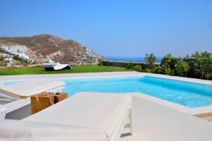 a swimming pool with a view of the ocean at Villa Castalia by Thalassa Residence Mykonos in Elia Beach