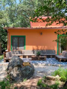 a house with couches and a rock in front of it at El Cielo de la Vera in Villanueva de la Vera