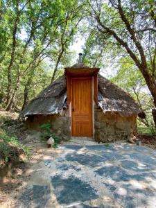 a small stone house with a thatch roof at El Cielo de la Vera in Villanueva de la Vera +58 photos