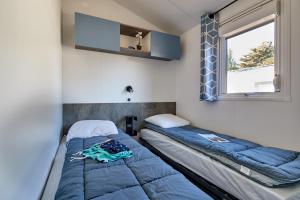 a room with two beds and a window at Camping Au Soir D'été in Mesquer +58 photos