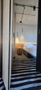 a hallway with a bed and a table in a room at Green Port Spa&Wellness Rent Partners in Kołobrzeg