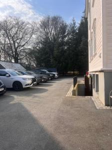 a parking lot with cars parked next to a building at Hatty's Habitat By Staysville in Stavanger