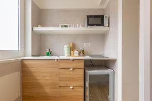 a small kitchen with a sink and a microwave at 4 Twins - Central Room in Bari +27 photos