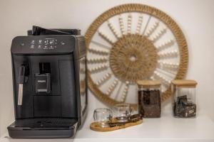 a coffee maker and glasses on a counter with a fan at 4 Twins - Central Room in Bari
