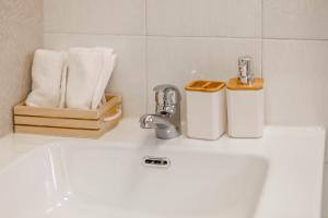 a bathroom sink with two faucets and towels at 4 Twins - Central Room in Bari