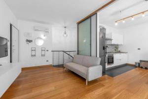 a living room with a couch and a kitchen at Milano-Rho Fiera Exclusive stay private parking in Rho