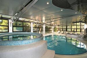 a large swimming pool in a building at Hotel Flores in Poreč